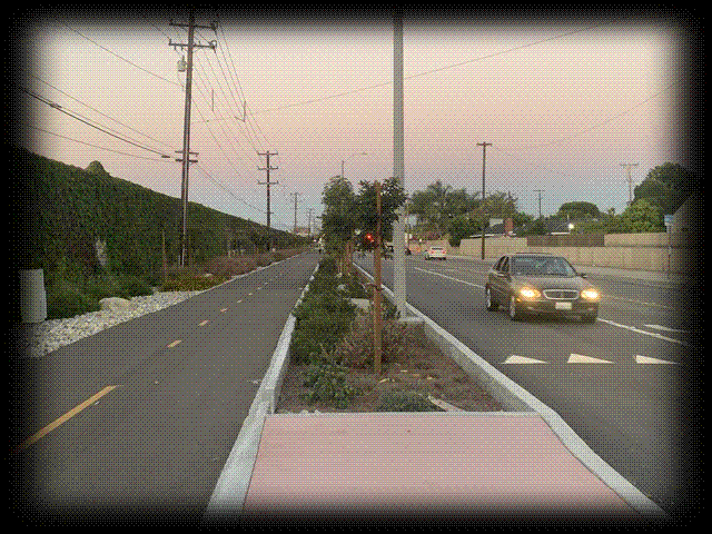 Class I bikeway on Garden Grove Boulevard, separated by concrete kerbs and trees.